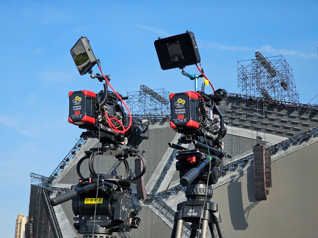 Two FX7 video cameras on tripods in front of LED screen at VAC Festival for Akima — Alchemist Films video production fixer in China