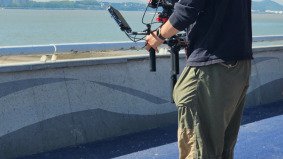 Director of Photography filming with Sony FX3 and stabilizer on a two-wheel vehicle in Hangzhou — supported by Alchemist Films, a China fixer video production company