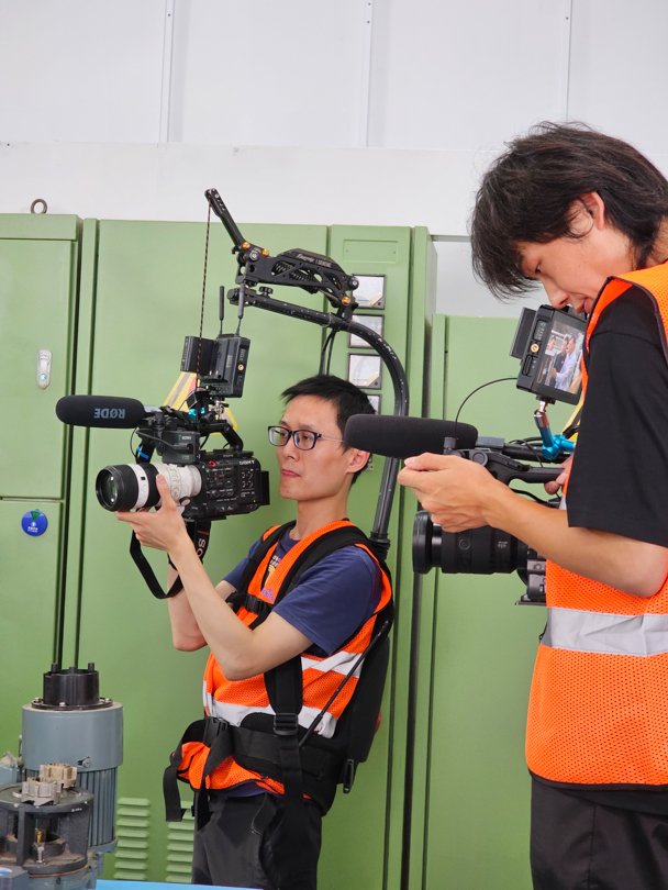 Two local Chinese Directors of Photography shooting content in a Shanghai factory for an international collaboration — supported by Alchemist Films’ China fixer video production services