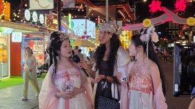 TikTok presenter Emma filming Korean visitors in traditional Chinese costumes at Yu Yuan Garden, with Alchemist Films providing production coordination and fixer services in China