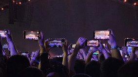 Group of fans holding phones to capture the giant LED screen during VAC Festival in Hefei, live event covered by Alchemist Films video production fixer team in China